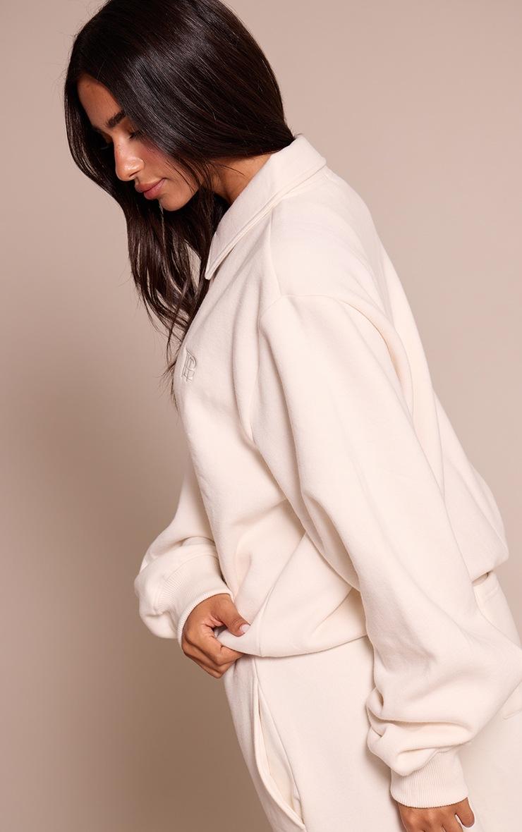 Pretty Little Thing Petite Cream Prettylittlething Polo Sweatshirt