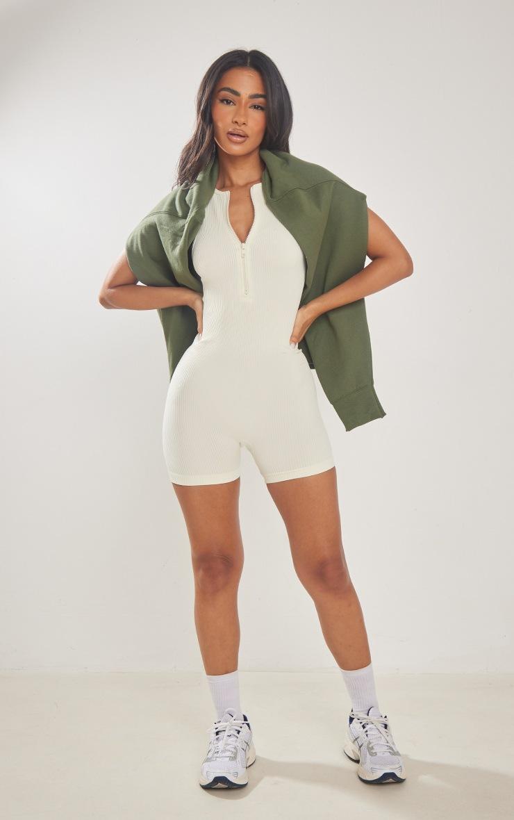 Pretty Little Thing Petite Cream Snatched Rib Zip Up Front Unitard