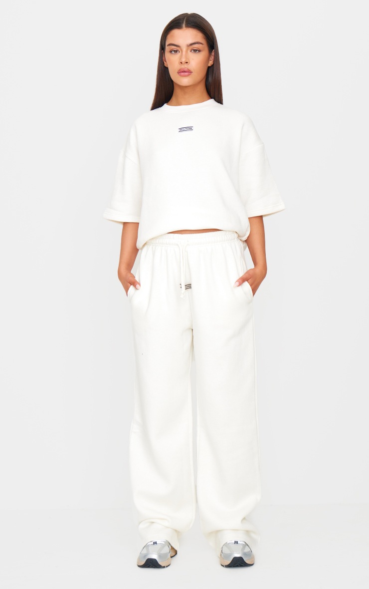 Pretty Little Thing PRETTYLITTLETHING Cream Badge Detail Mid Rise Wide Leg Sweatpants